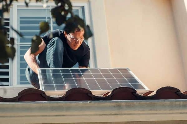 The Great Escape: How Self-Sufficient Heating and Gardening Combat Rising Living Costs 2 installing solar panel on roof, domestic solar panel, small